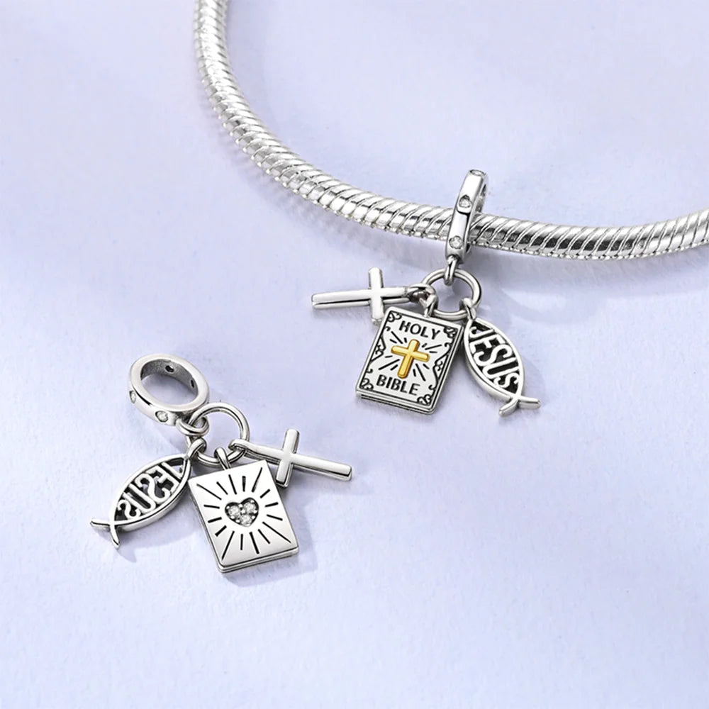 Silver bracelet with religious charms on a light purple background